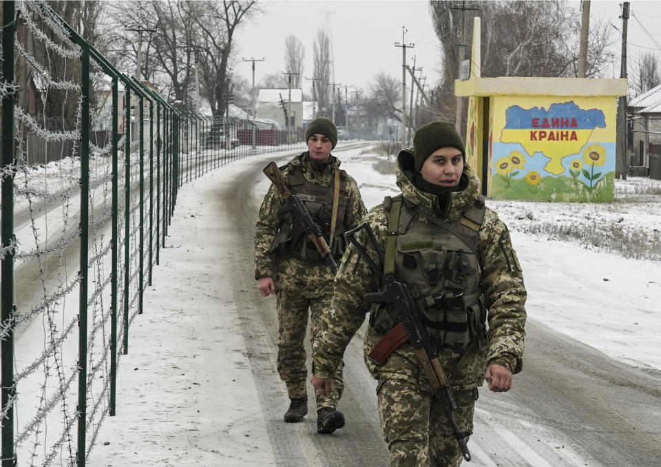 Ukrainian border guards patrol an area along the Ukrainian side of the Ukraine - Russia border in Milove town, eastern Ukraine, Sunday, Dec. 2, 2018. On a map, Chertkovo and Milove are one village, crossed by Friendship of Peoples Street which got its name under the Soviet Union. On the streets in both places, people speak a mix of Russian and Ukrainian without turning choice of language into a political statement as many did after the question of language became one of the many thorny issues that has fueled the conflict between Ukraine and Russia since Moscow annexed Crimea in March 2014 and threw its weight behind separatists in the east by clandestine dispatches of troops and weapons. (AP Photo/Evgeniy Maloletka)