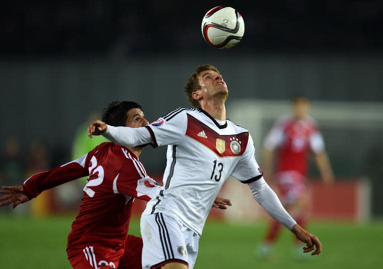 Georgia's Giorgi Navalovski (L) and Germany's Thomas Mueller vie for the ball during the Euro 2016 qualifying football match in Tbilisi , Georgia on March 29, 2015