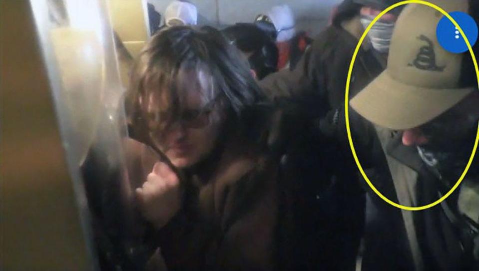 Bernard Sirr, circled at right, is seen in a screen grab from video taken inside a tunnel at the U.S. Capitol during the Jan. 6 riot.