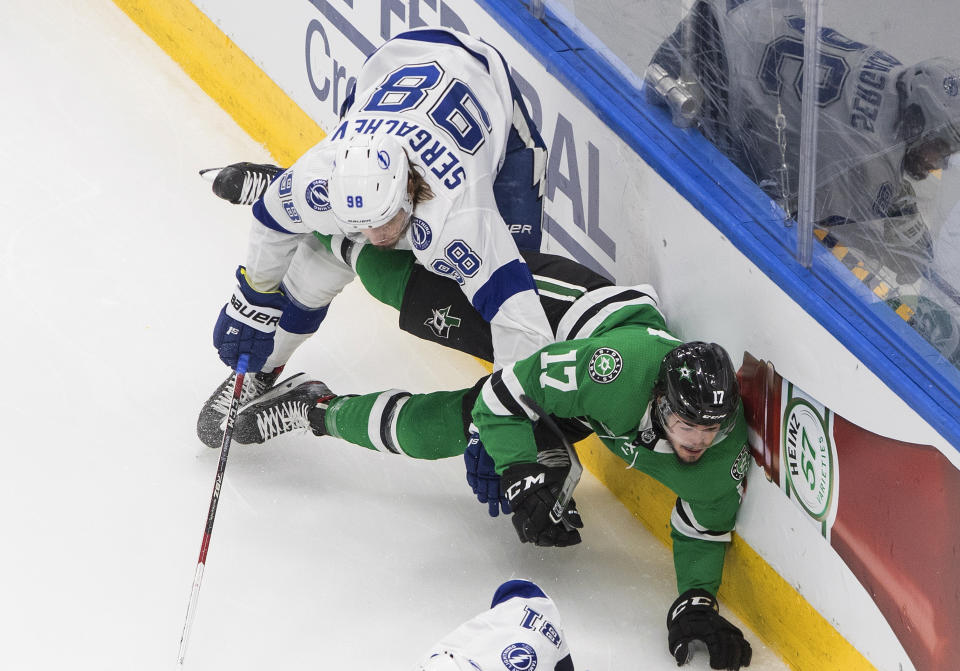 Tampa Bay Lightning defenseman Mikhail Sergachev (98) checks Dallas Stars right wing Nick Caamano (17) during the first period of Game 3 of the NHL hockey Stanley Cup Final, Wednesday, Sept. 23, 2020, in Edmonton, Alberta. (Jason Franson/The Canadian Press via AP)