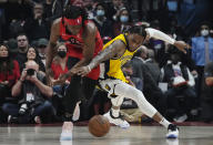 Toronto Raptors forward Precious Achiuwa (5) and Indiana Pacers forward Oshae Brissett (12) battle for the ball during the first half of an NBA basketball game, Wednesday, Oct. 27, 2021 in Toronto. (Nathan Denette/The Canadian Press via AP)