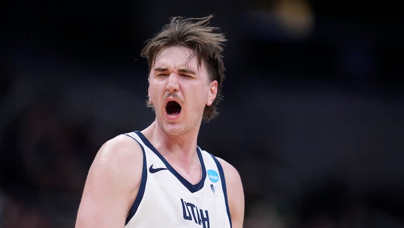 Utah State center Isaac Johnson reacts after making a basket in the second half of a first-round college basketball game against TCU in the NCAA Tournament, Friday, March 22, 2024, in Indianapolis.