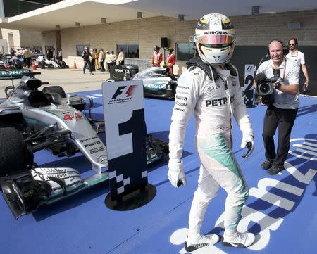 Formula One F1 - U.S. Grand Prix - Circuit of the Americas, Austin, Texas, U.S., 23/10/16. Mercedes' Lewis Hamilton of Britain walks in front of his car after winning the race. REUTERS/Adrees Latif