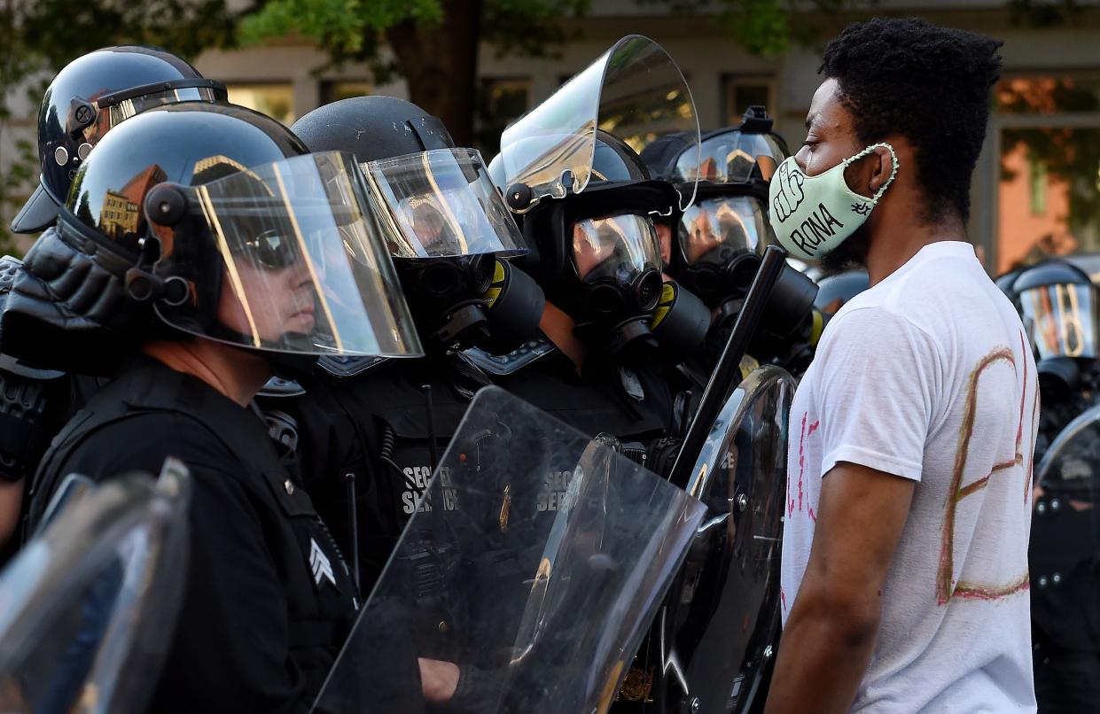 Law enforcement officers face off with demonstrators outside the White House as part of a wave of anti-racism protests nationwide. (OLIVIER DOULIERY/AFP via Getty Images)