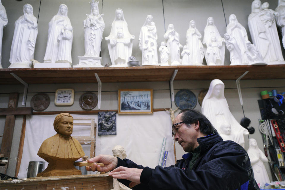 In this Nov. 16, 2019, photo, Mitsuho Nakata, a Catholic statue artist, works at his workshop near the Urakami Cathedral in Nagasaki, southern Japan. Pope Francis will start his first official visit to Japan in Nagasaki, ground zero for the Christian experience in a nation where the Catholic leader once dreamed of living as a missionary. (AP Photo/Eugene Hoshiko)