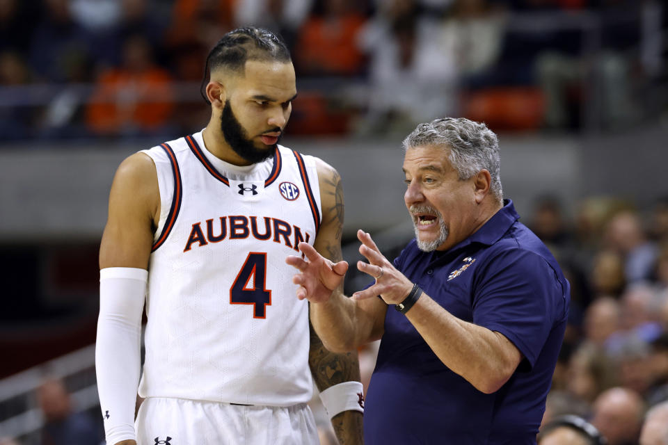 Auburn head coach Bruce Pearl talks with forward Johni Broome during the second half of the team's NCAA college basketball game against Mississippi on Saturday, Jan. 20, 2024, in Auburn, Ala. (AP Photo/Butch Dill)