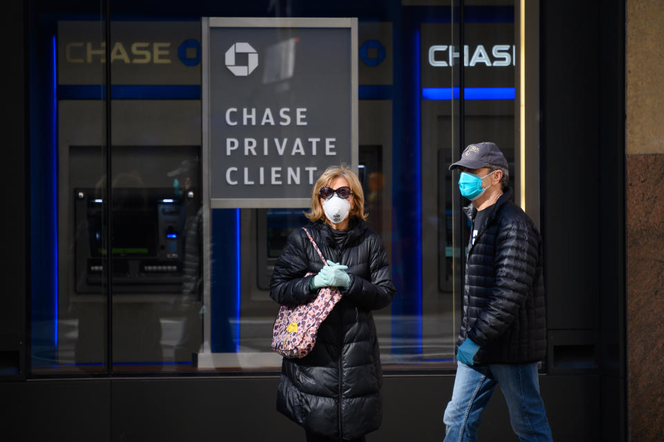 NEW YORK, NY - MARCH 27: People are seen wearing protective face masks outside Chase Bank in Murray Hill as the coronavirus continues to spread across the United States on March 27, 2020 in New York City. The World Health Organization declared coronavirus (COVID-19) a global pandemic on March 11th. (Photo by Noam Galai/Getty Images)