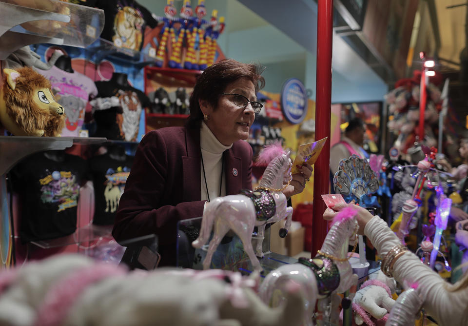 <p>Concessions manager Jeannie Hamilton helps a customer at one of the many memorabilia booths after a show, Saturday, May 6, 2017, in Providence, R.I. While people talk about running away with the circus as freeing, Hamilton said she sometimes felt constrained _ either stuck at the arena or stuck on the train. But Hamilton decided to spend that last trip soaking it all in. “Anytime the train was moving, I was on the vestibule,” she said, referring to the small standing area between train cars. “Now that it’s coming to an end, I was trying to enjoy every minute of it.” (Photo: Julie Jacobson/AP) </p>