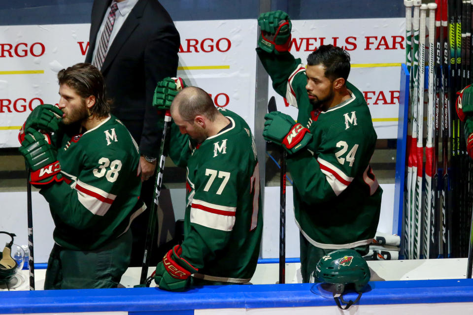 EDMONTON, ALBERTA - AUGUST 07:  Matt Dumba #24 of the Minnesota Wild raises his fist during the national anthem prior to Game Four of the Western Conference Qualification Round against the Vancouver Canucks prior to the 2020 NHL Stanley Cup Playoffs at Rogers Place on August 07, 2020 in Edmonton, Alberta. (Photo by Jeff Vinnick/Getty Images)