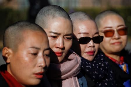 Yuan Shanshan, Li Wenzu, Liu Ermin, Wang Qiaoling, wives of prominent Chinese rights lawyers, pose for pictures after shaving their heads in protest over the government's treatment of their husbands in Beijing, China, December 17, 2018. REUTERS/Thomas Peter