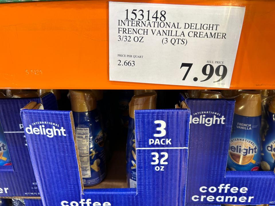 internatinoal delight blue breakfast creamer display with orange beam above with 7.99 price sticker stuck to it