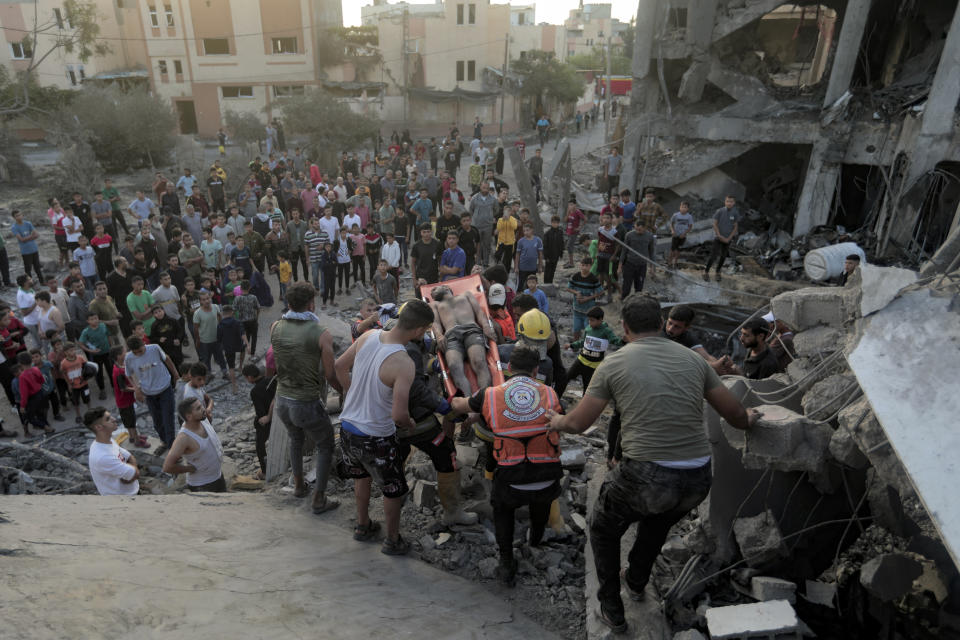 Palestinians evacuate a survivor from a house hit by an Israeli airstrike in Khan Younis.