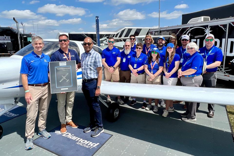 A delegation from Middle Tennessee State University’s Aerospace Department stands next to its new Diamond DA40 XLT aircraft Wednesday, March 29, at Sun ’n Fun Aerospace Expo, one of the nation’s largest annual aviation gatherings. The delegation visited the event to accept the first of eight new Diamond aircraft to be added to the university’s fleet. Pictured second from left is Trevor Mustard, Diamond head of sales and marketing, who presented a special token of appreciation of the company’s longstanding business partnership with MTSU.