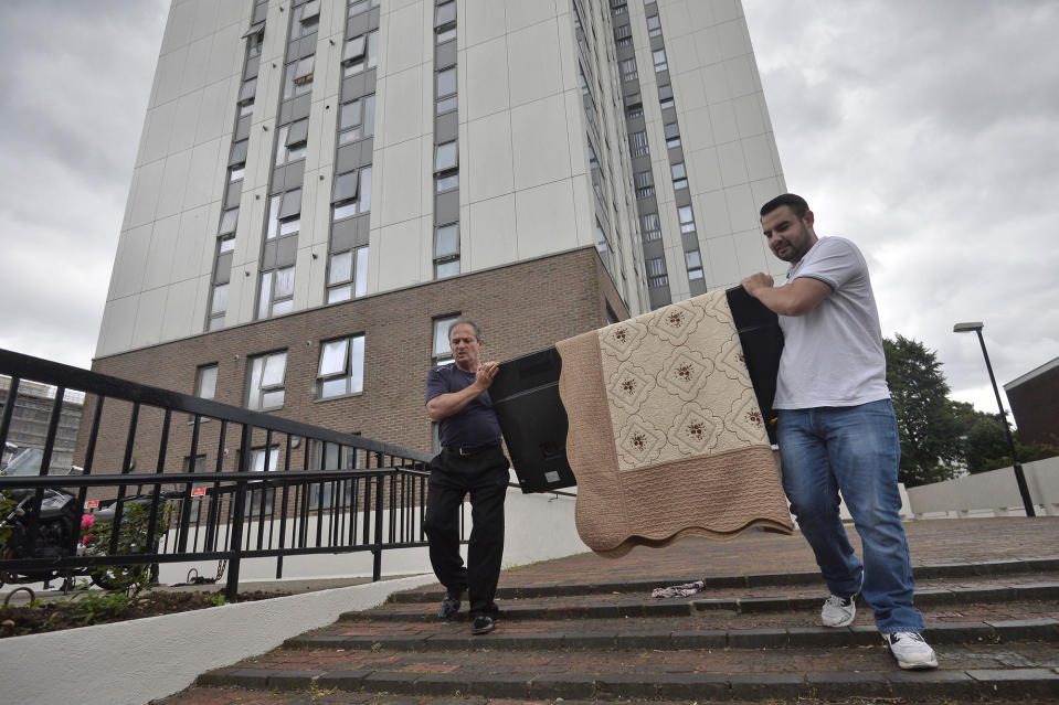 Two men carry a television set from the Dorney Tower