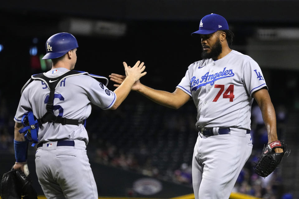 Los Angeles Dodgers catcher Will Smith and pitcher Kenley Jansen (74) celebrate after defeating the Arizona Diamondbacks 4-2 during a baseball game, Friday, Sept. 24, 2021, in Phoenix. (AP Photo/Rick Scuteri)