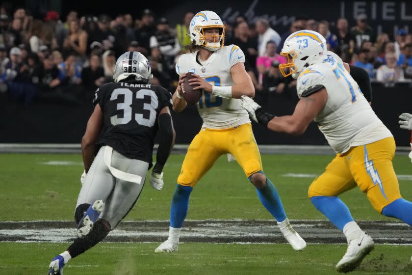 Chargers quarterback Justin Herbert looks to pass against the Las Vegas Raiders during the first half Dec. 4, 2022.