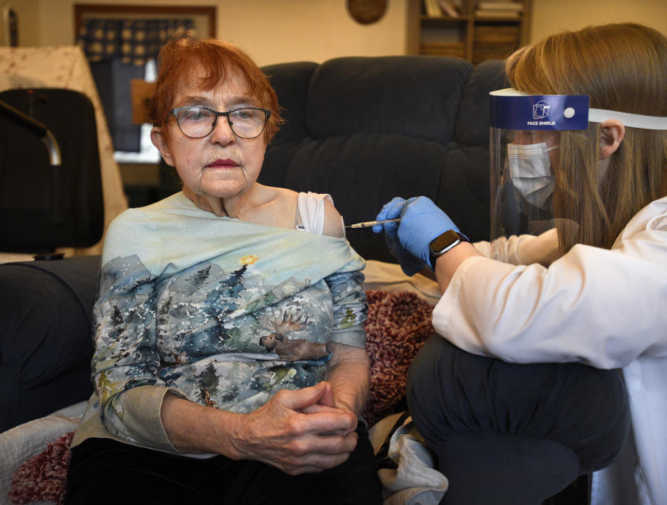 FILE - In this Friday, Dec. 18, 2020, file photo, Mary Ann Olsen receives a COVID-19 vaccine from pharmacist Kalli Kline at her residence in Ketchikan, Alaska. Alaska has dropped restrictions on who can get a COVID-19 vaccination, opening eligibility to anyone 16 or older who lives or works in the state in a move that Gov. Mike Dunleavy said could help Alaska's pandemic-battered economy. The Republican, who highlighted his own bout with COVID-19 in making the announcement Tuesday, said Alaska is the first U.S. state to remove eligibility requirements. (Dustin Safranek/Ketchikan Daily News via AP)