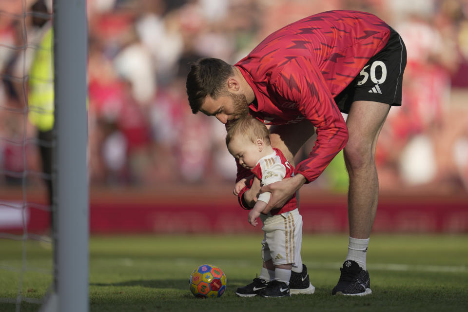 Arsenal's goalkeeper Matt Turner plays with his son after the English Premier League soccer match between Arsenal and Wolverhampton Wanderers at the Emirates Stadium in London, Sunday, May 28, 2023. (AP Photo/Kin Cheung)