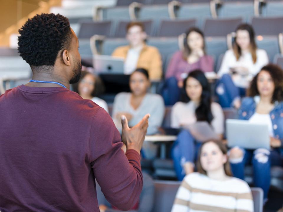 College professor gives a lecture in front of a group of students