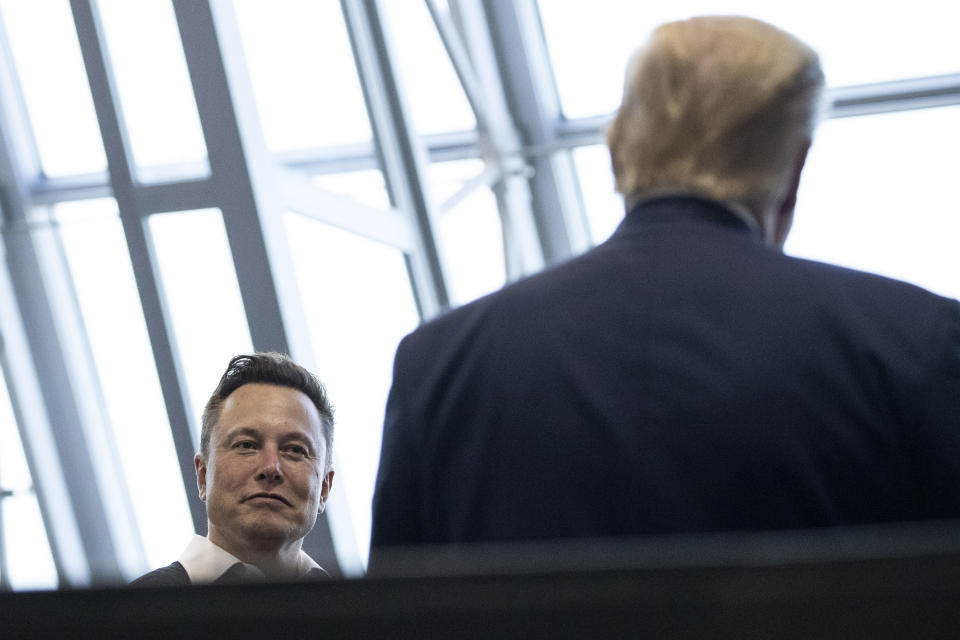 FILE - Tesla and SpaceX Chief Executive Officer Elon Musk talks with President Donald Trump after viewing the SpaceX flight to the International Space Station, at Kennedy Space Center, May 30, 2020, in Cape Canaveral, Fla. Trump and Musk share a reputation as disrupters. Now, they're grappling with tribulations that may be unlike anything thrown at them before. (AP Photo/Alex Brandon, File)