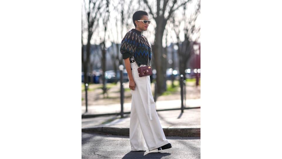 Tamu McPherson in white jeans, a chunky knit and glorious Chanel camera bag. 