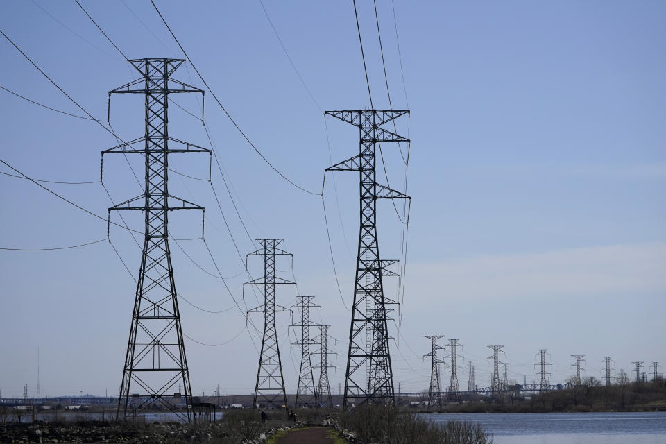 Power lines stretch into the distance over the Meadowlands in North Arlington, N.J., Tuesday, April 6, 2021. President Joe Biden is setting about convincing America it needs his $2.3 trillion infrastructure plan, deputizing a five-member "jobs Cabinet" to help in the effort. But the enormity of his task is clear after Senate Minority Leader Mitch McConnell's vowed to oppose the plan "every step of the way." (AP Photo/Seth Wenig)