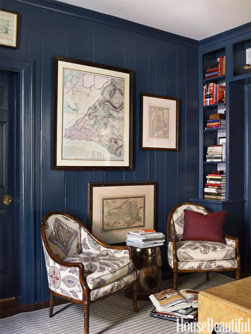<p>Painting a small living room a dark color can be helpful. It camouflages the fact that it's small, and ups the cozy vibes. Bonus? Navy blue is totally timeless. </p>