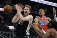 San Antonio Spurs center Jakob Poeltl (25) is blocked by Oklahoma City Thunder forward Darius Bazley (7) during the second half of an NBA basketball game, Wednesday, Jan. 19, 2022, in San Antonio. (AP Photo/Eric Gay)