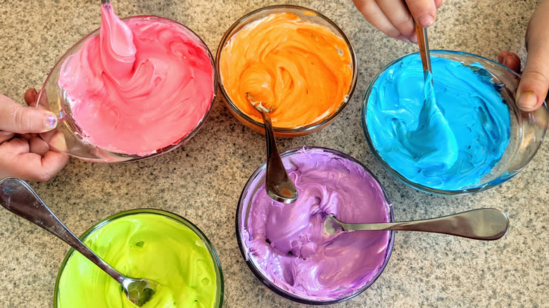 Bowls of colorful icing for decorating cookies
