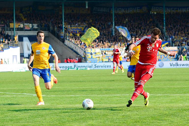 Mario Mandzukic (right) scores for Bayern Munich in a league game against Eintracht Braunschweig in Braunschweig on April 19, 2014