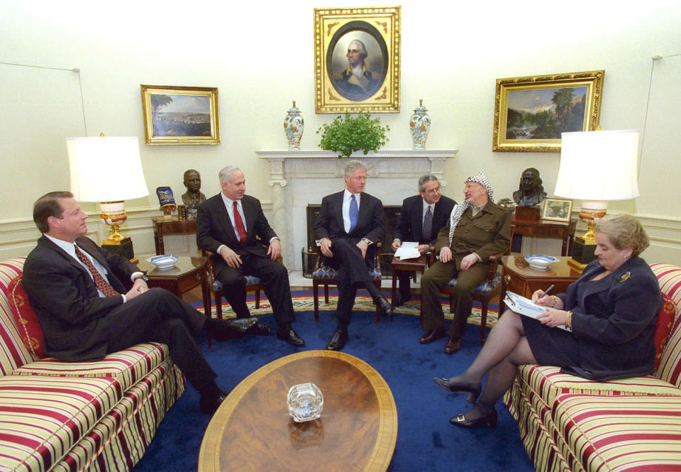 President Clinton meets with Palestinian President Yasser Arafat and Israeli President Benjamin Netanyahu in the Oval Office on October 15 along with Vice President Al Gore (L) and U.S. Secretary of State Madeleine Albright (R).