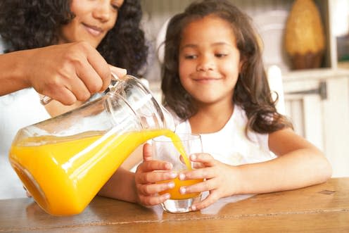 <span class="caption">Yes, fruit juice contains natural sugar, but it has other benefits over sugar-sweetened drinks.</span> <span class="attribution"><a class="link " href="https://www.shutterstock.com/image-photo/mother-pouring-fresh-orange-juice-jug-118749622?src=V4WQJoCPLnRRJoPVNE_XMQ-1-8" rel="nofollow noopener" target="_blank" data-ylk="slk:Carlos Horta/Shutterstock;elm:context_link;itc:0;sec:content-canvas">Carlos Horta/Shutterstock</a></span>