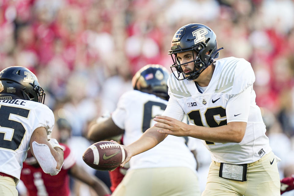 Purdue quarterback Aidan O'Connell (16) hands off to running back Devin Mockobee during the second half of an NCAA college football game Saturday, Oct. 22, 2022, in Madison, Wis. Wisconsin won 35-24. (AP Photo/Andy Manis)