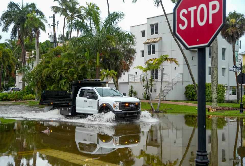 A City of Naples storm water vehicle travels along a flooded section of Gulf Shore Boulevard South as rain falls in Naples on Tuesday, June 11, 2024.
