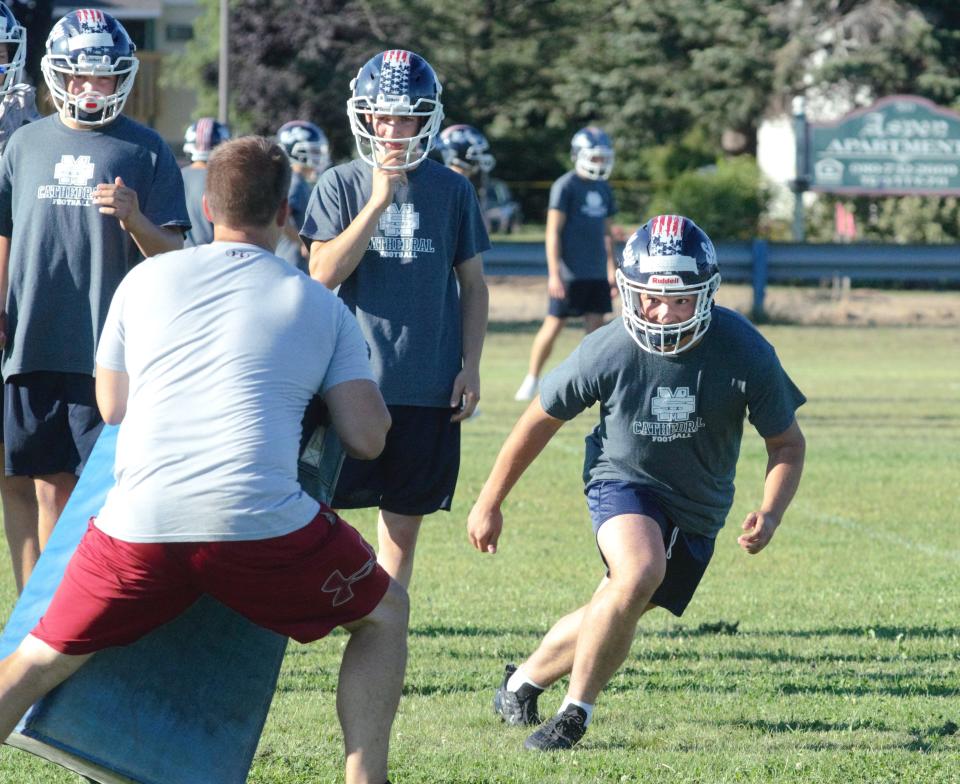 A Gaylord St. Mary's player goes through a blocking pad drill during a practice on Tuesday, August 9.