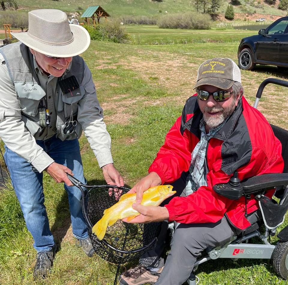Volunteer and veteran Jack Cremens (left) shares a smile with participant Kevin Crites during the Project Healing Waters fishing trip to  Rainbow Falls Mountain Trout Inc. in Woodland Park June 7, 2023.