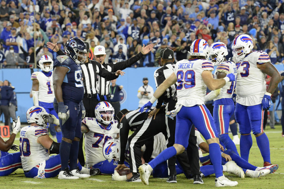 Buffalo Bills players sit on the ground as officials place the ball short of the distance needed for a first down in the final seconds of an NFL football game against the Tennessee Titans Monday, Oct. 18, 2021, in Nashville, Tenn. The Titans won 34-31. (AP Photo/Mark Zaleski)