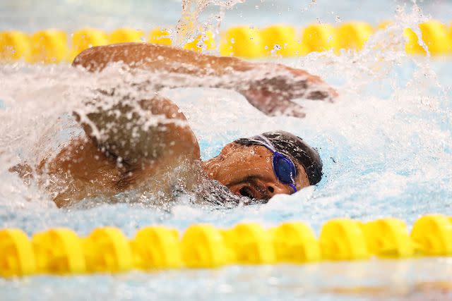 <p>Dean Mouhtaropoulos/Getty</p> Garrett Kuwada of Team USA competes in the Men's 50m Freestyle Final during the Swimming on day four of the Invictus Games The Hague 2020, held in April 2022.