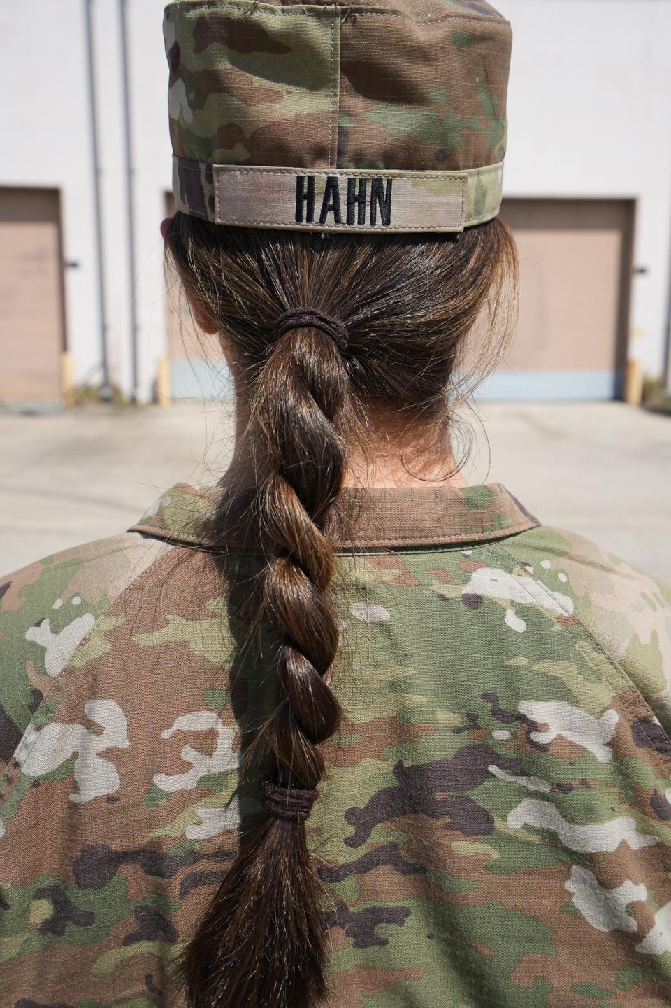 At 23,1st Lt. Delaney Hahn is a field artillery officer and commands a team of mostly men at Fort Stewart on March 21, 2023, in Georgia. The military recently allowed women to wear braids, which Hahn said was a great relief when she has her helmet on.