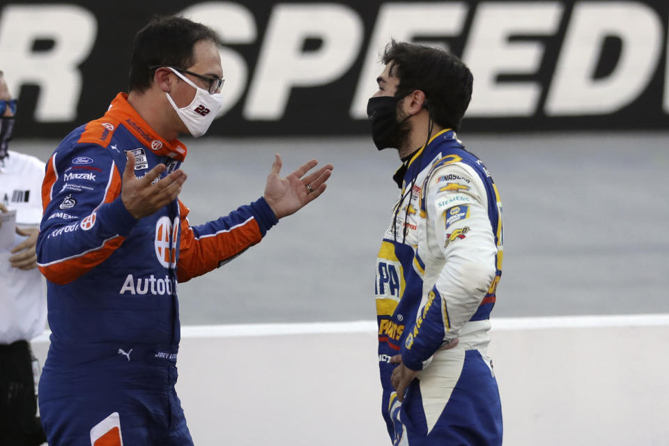 Drivers Joey Logano, left, and Chase Elliott talk following a NASCAR Cup Series auto race at Bristol Motor Speedway Sunday, May 31, 2020, in Bristol, Tenn. (AP Photo/Mark Humphrey)