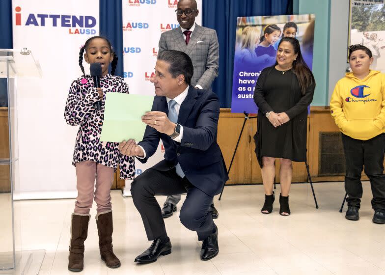 LOS ANGELES, CA-FEBRUARY 3, 2023:LAUSD Superintendent Alberto Carvalho holds a paper written by 4th grader Tinniya Wilson as she reads her prepared remarks addressing the media about the benefits of having a tutor and mentor during a press conference at Compton Ave. Elementary School STEAM Academy in Los Angeles. In background from left to right are Andre Spicer, LAUSD Region South Interim Superintendent, Denise Miranda, Ed.D. Director for LAUSD, and Michael Arrellano, a 4th grader at the school who also benefited from having a tutor. Carvalho announced a new mentoring initiative, Everyone Mentors LA, during the press conference. The mentoring initiative will invest in the lives of historically underserved students. It will match students contending with declining grades, chronic absenteeism, social emotional support and other challenges that have inhibited their academic success with a mentor from the Los Angeles community. (Mel Melcon / Los Angeles Times)