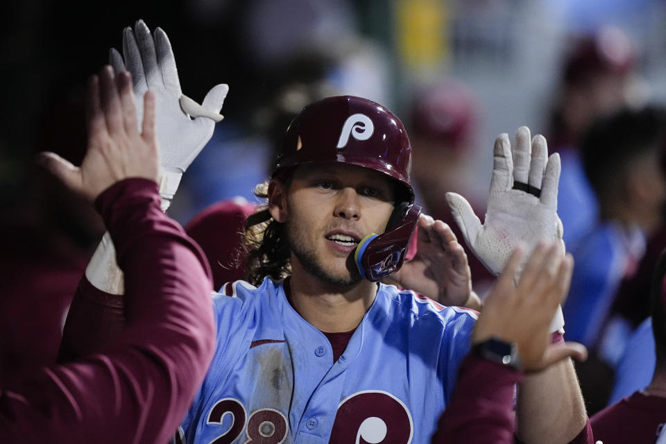 Philadelphia Phillies' Alec Bohm celebrate with teammates after hitting a home run off of Pittsburgh Pirates' Jared Jones during the fourth inning of a baseball game, Thursday, April 11, 2024, in Philadelphia. (AP Photo/Matt Rourke)