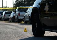 <p>An evidence marker sits on the road in front of a Texas Department of Public Safety vehicle outside the First Baptist Church in Sutherland Springs, Texas, Nov. 5, 2017. (Photo: R. Tomas Gonzalez/EPA-EFE/REX/Shutterstock) </p>