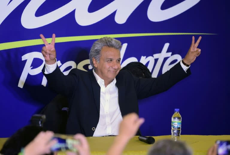 Lenin Moreno, the presidential candidate of the governing Alianza PAIS party, makes the "V for victory" sign to supporters at a hotel in Quito shortly before the results of the country's general elections are announced on February 19, 2017