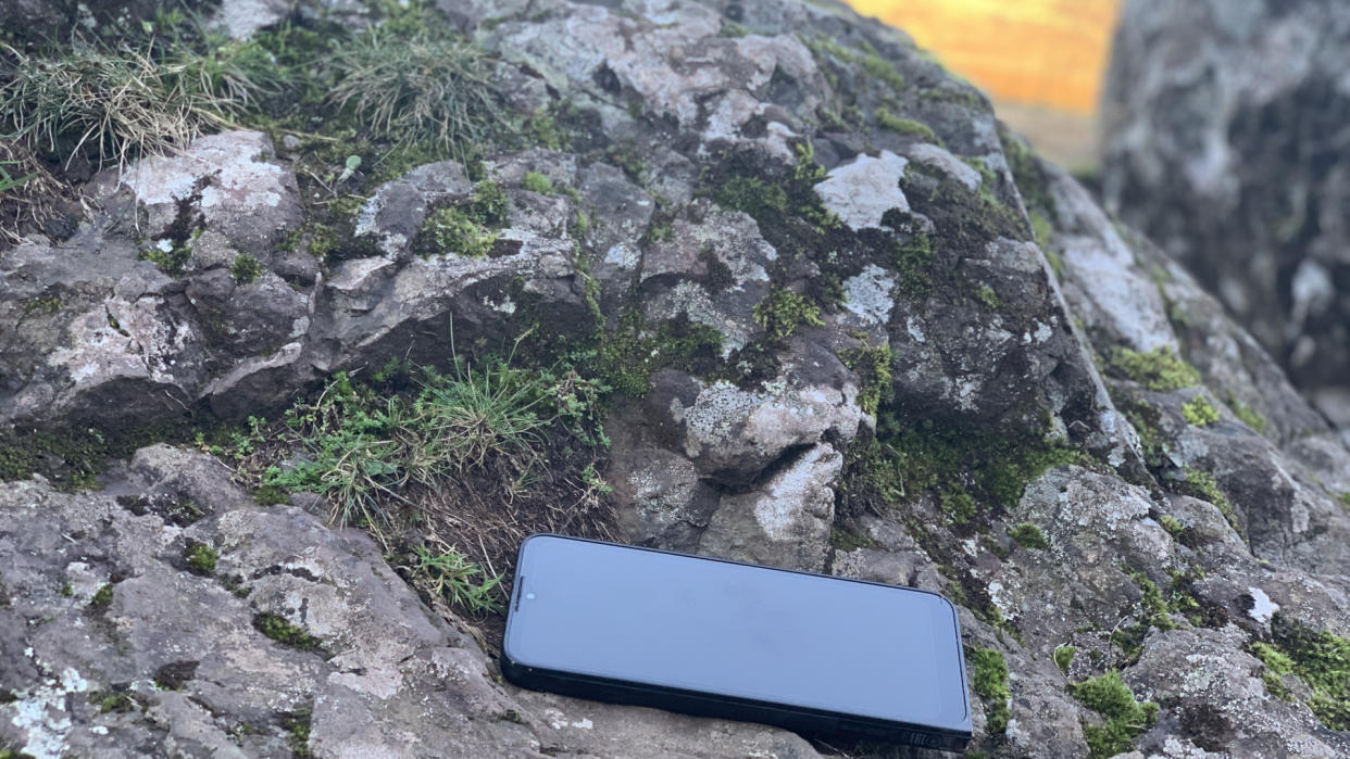  A phone lying on a rock. 