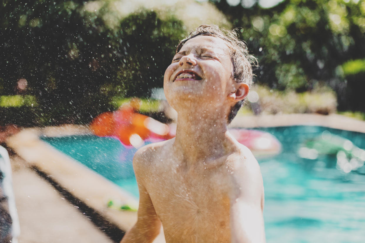 a little boy at poolside in summer