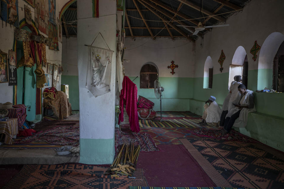 Tigrayan men who fled the conflict in Ethiopia's Tigray region, pray during Sunday Mass inside a church, near Umm Rakouba refugee camp in Qadarif, eastern Sudan, Nov. 29, 2020. (AP Photo/Nariman El-Mofty)