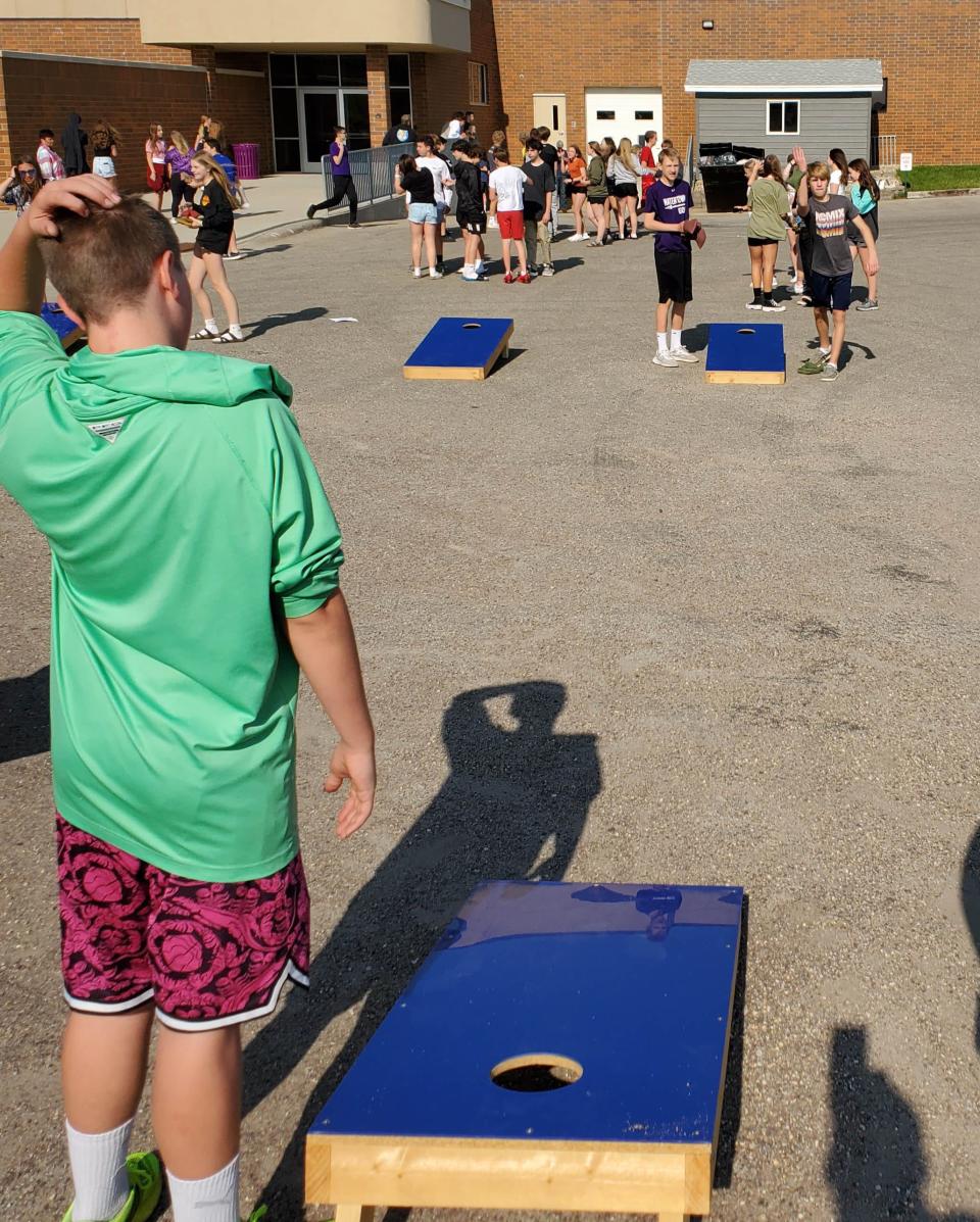 Students play some cornhole during the Watertown Middle School Arrowfest on Friday, May 26, 2023.