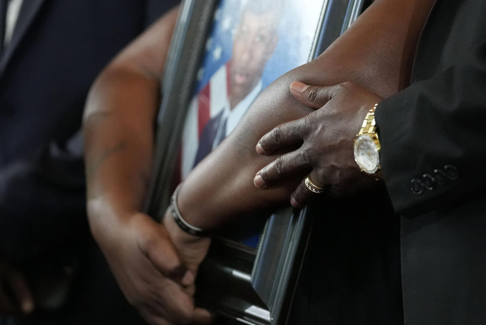 Chantemekki Fortson, mother of slain Roger Fortson, a U.S. Air Force senior airman, holds a photo of her son during a news conference with attorney Ben Crump on Monday, June 3, 2024, in Atlanta. (AP Photo/Brynn Anderson)