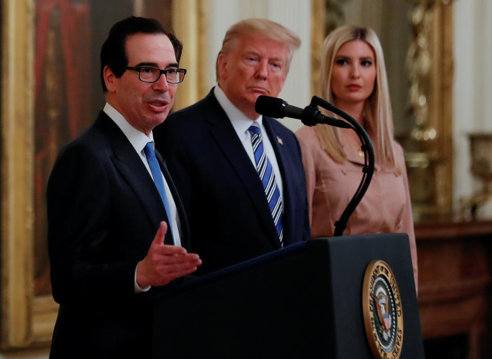 Treasury Secretary Steven Mnuchin speaks as U.S. President Donald Trump and White House senior adviser Ivanka Trump listen during an East Room event highlighting Paycheck Protection Program (PPP) loans for small businesses adversely affected by the coronavirus disease (COVID-19) outbreak, at the White House in Washington, U.S., April 28, 2020. REUTERS/Carlos Barria